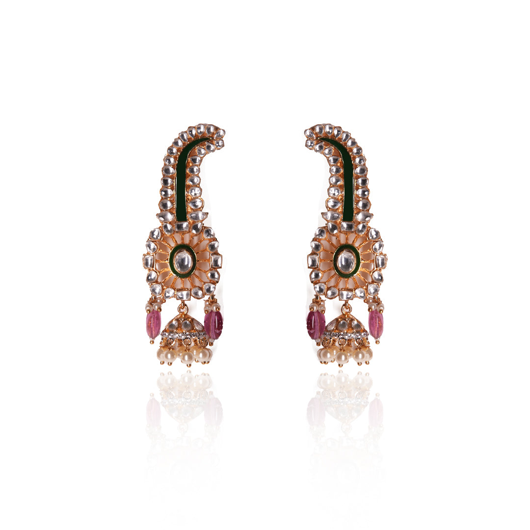 Long gold Suhani Earrings by Vasundhara with curved top, pink bead accents, and pearl jhumka embellishments.