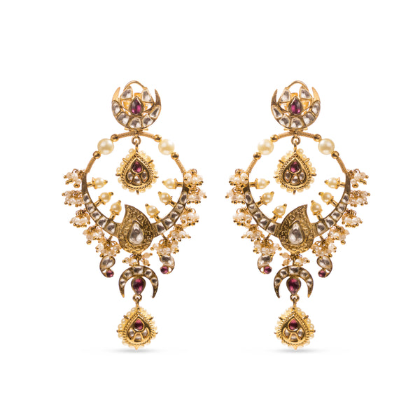 Traditional Masuma Earrings from Vasundhara with pearls, kundan, and pink gemstones, placed on a white backdrop.