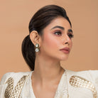 A model in white and gold top presenting the Aaravi Earrings