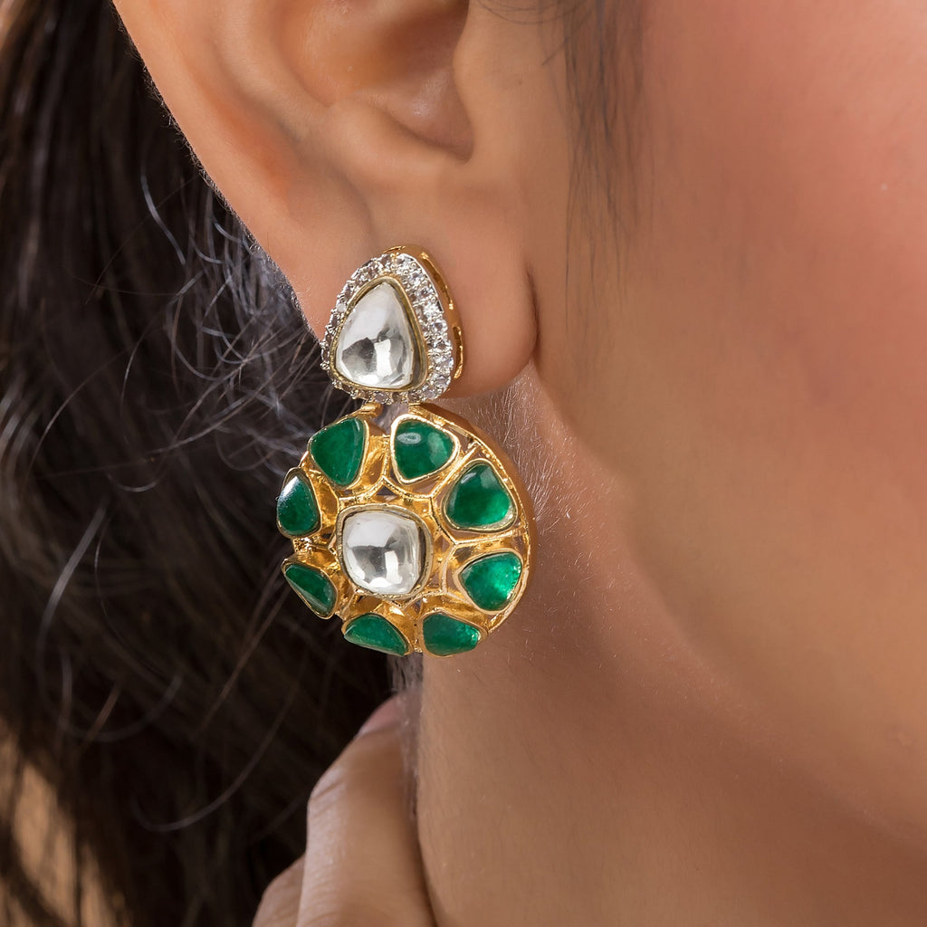 Asra Earrings dangling from an ear