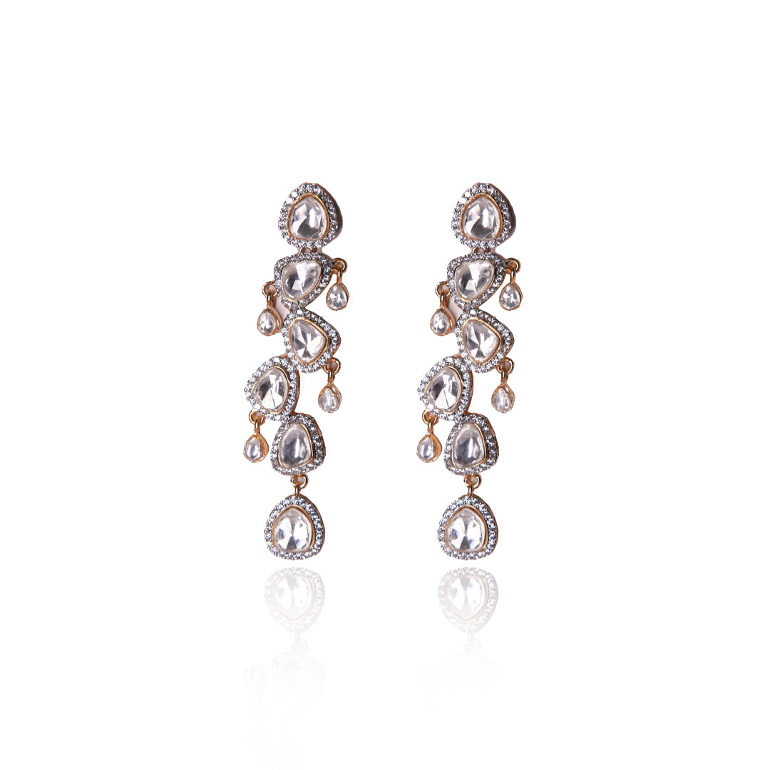 Elegant Prisha Earrings by Vasundhara showcasing cascading kundan stones and crystal detailing, placed on a white backdrop.