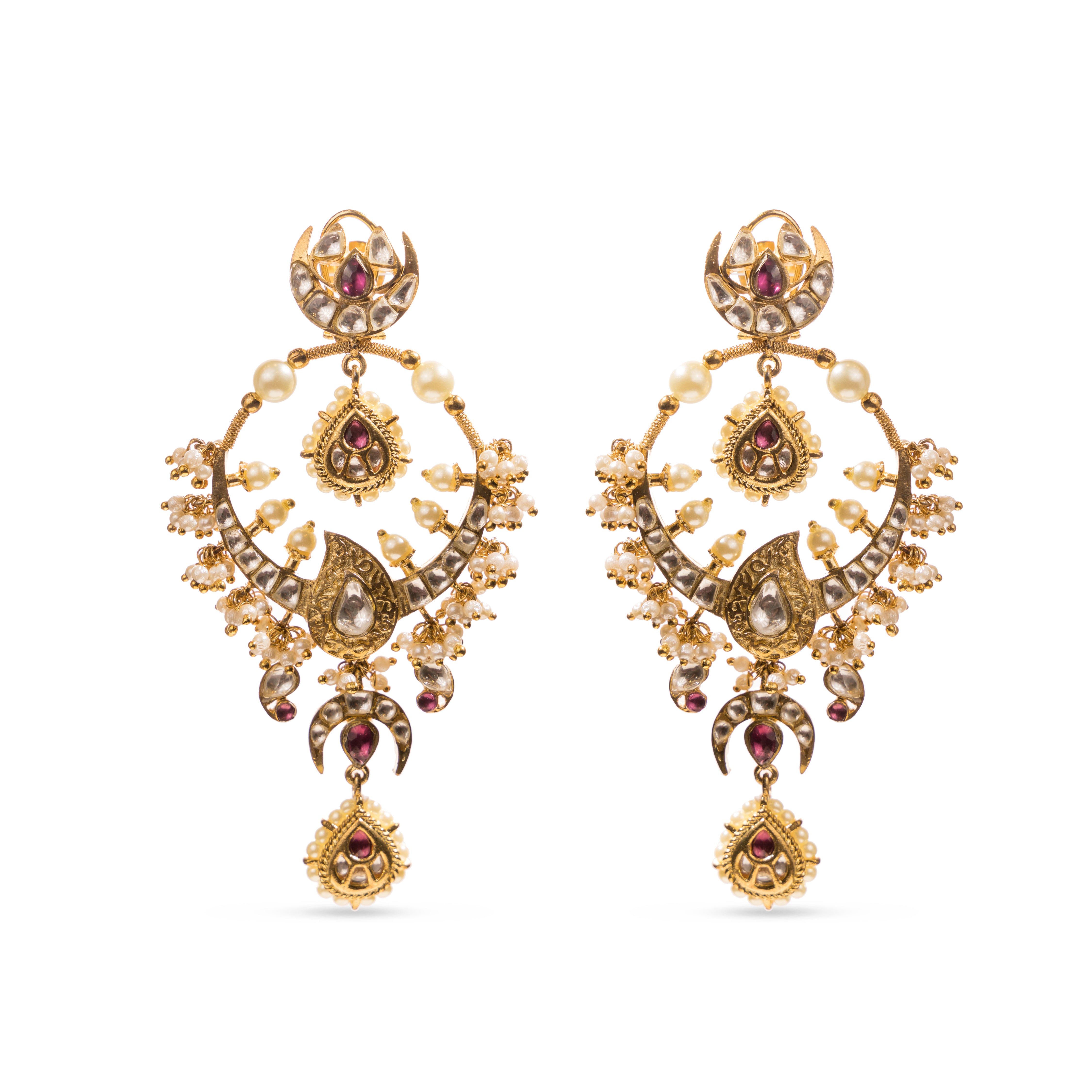Traditional Masuma Earrings from Vasundhara with pearls, kundan, and pink gemstones, placed on a white backdrop.