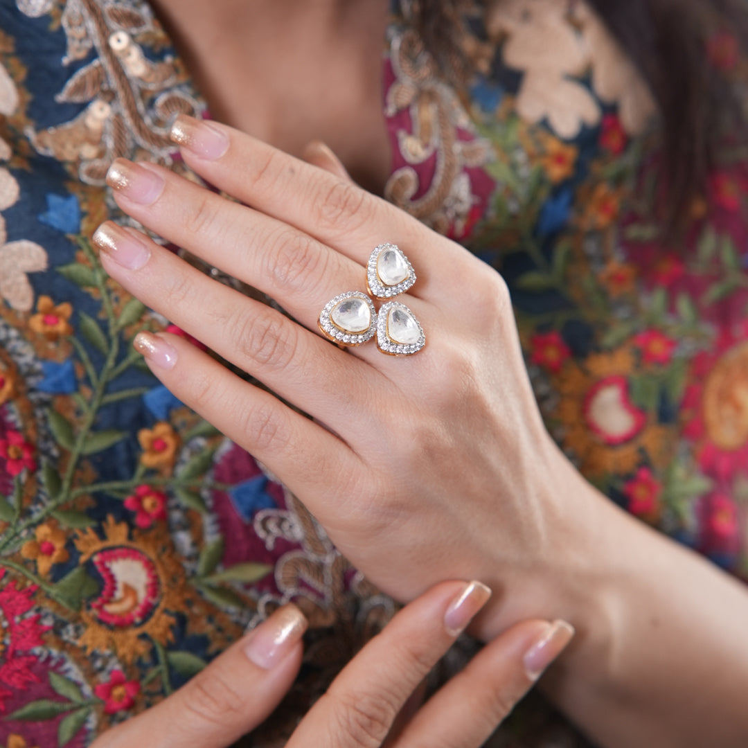 Mira Ring by Vasundhara, a trio of pear-shaped kundan stones with diamond accents, adorning a woman’s graceful hand.