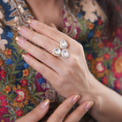 Mira Ring by Vasundhara, a trio of pear-shaped kundan stones with diamond accents, adorning a woman’s graceful hand.