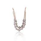 The Prisha Necklace by Vasundhara showcases pearls and kundan stones, styled on a woman’s neck in soft lighting.