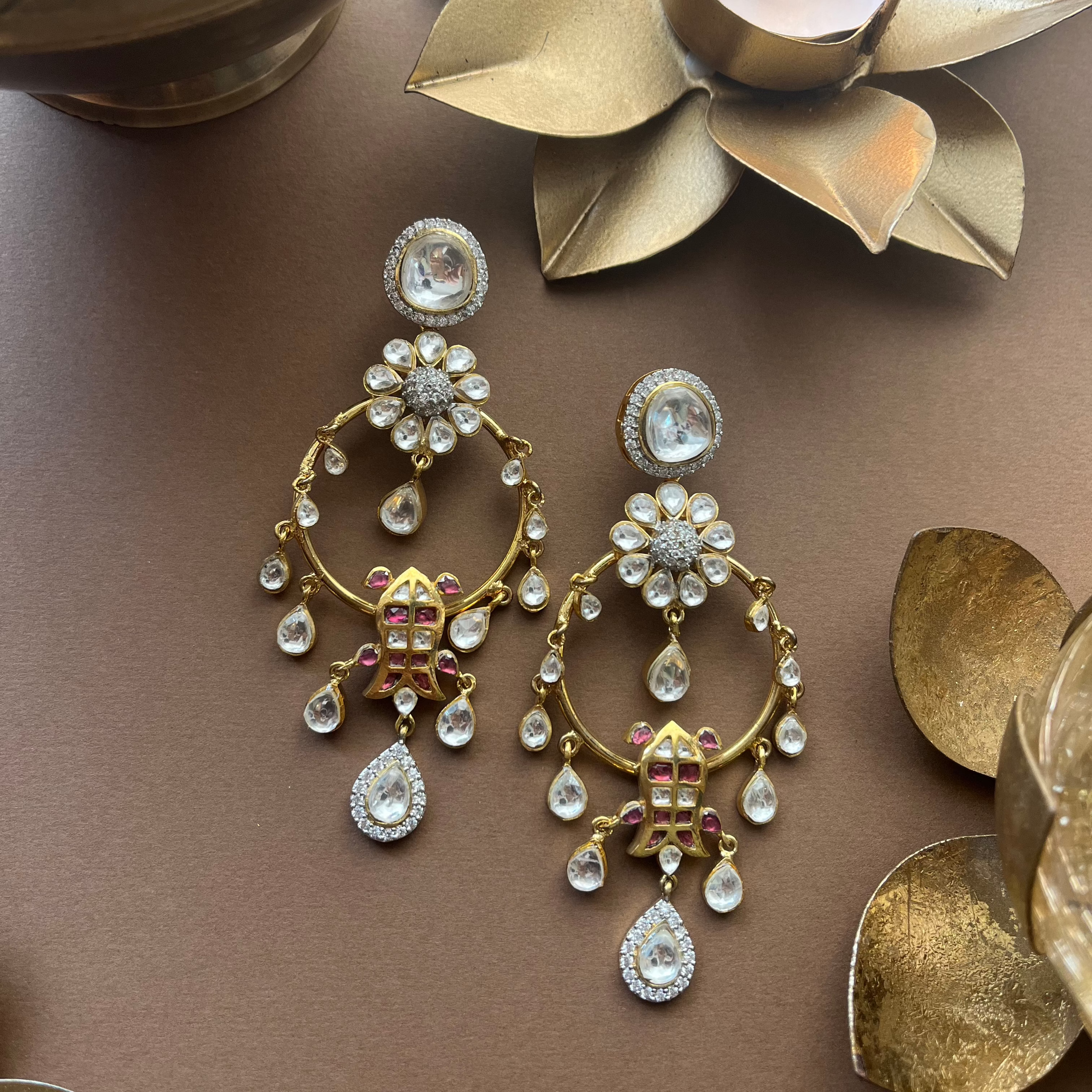 A Stunning View of Veda Earrings Against a Brown Backdrop