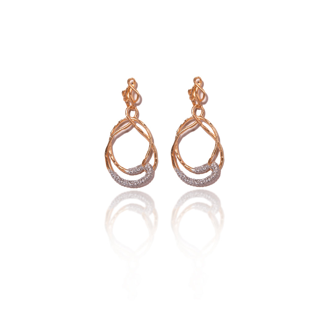 Elegant Backstage Earrings with twisted gold design and crystal accents, captured against a clean white background.