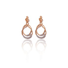 Elegant Backstage Earrings with twisted gold design and crystal accents, captured against a clean white background.