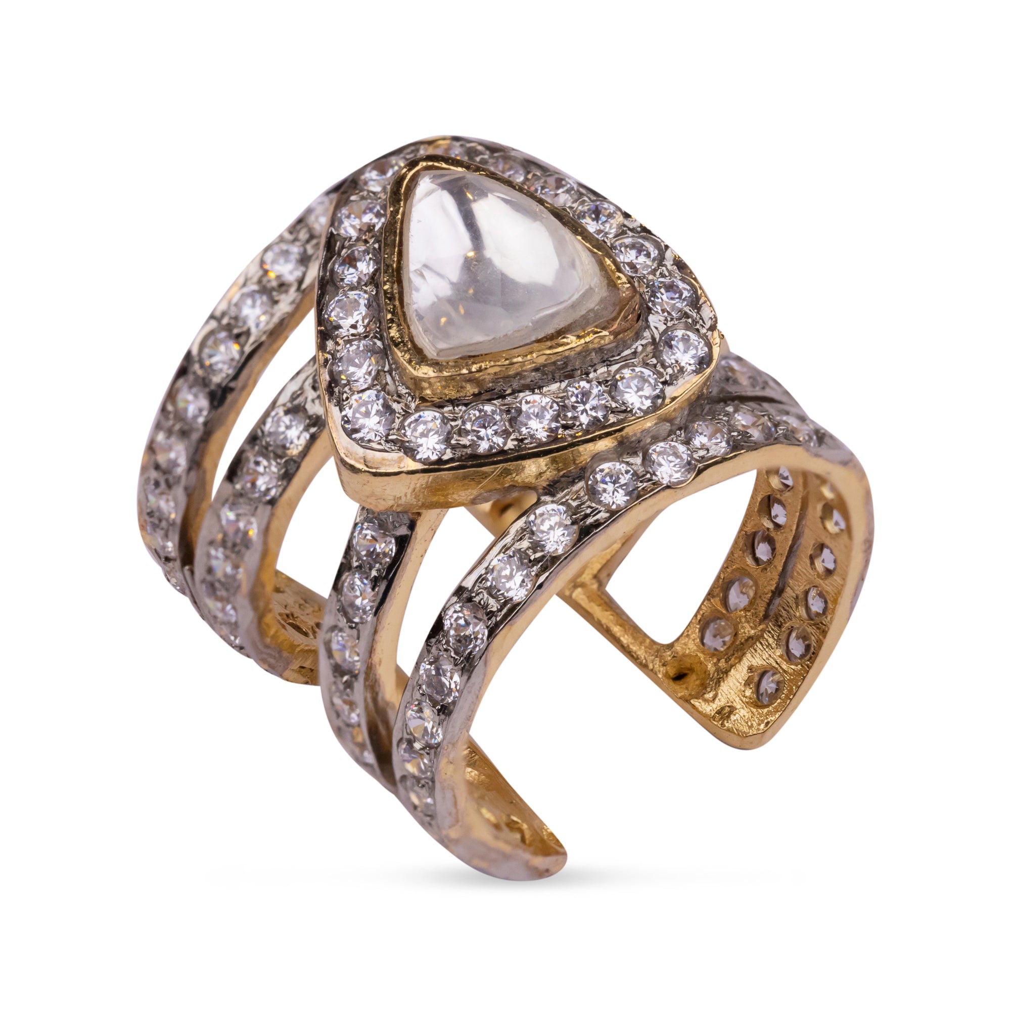Vasundhara’s Iqra Ring, bold gold and diamond-studded band with a pear-shaped kundan stone placed on white display.